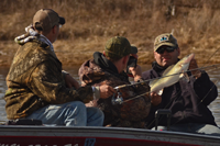 image of walleye fishermen taking picture of rainy river walleye