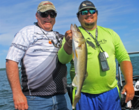 image of Andy Walsh with leech lake walleye