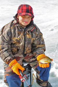 image of ice fishing kid holding sunfish