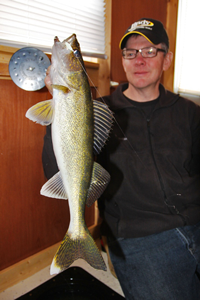 image of Dan Johnson holding Walleye in Red Lake Rental Shelter