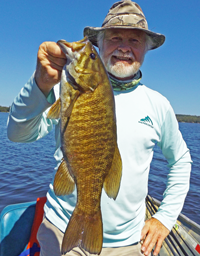 image of greg clusiau with big smallmouth bass