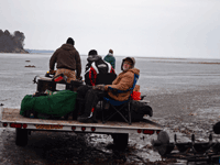 image of ice fishermen heading onto the lake