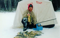 image of a stack of crappies with greg clusiau in background