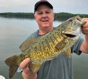 image of Mikle Rogers with big Smallmouth Bass