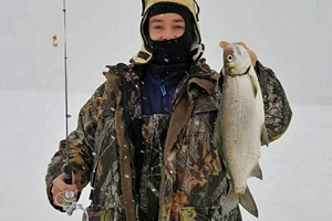 image of ice fisherman with big tulibee