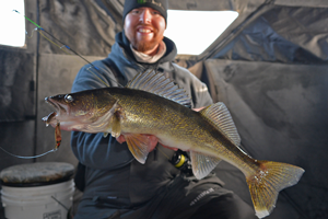 image of Dustin Monson with Mille Lacs walleye