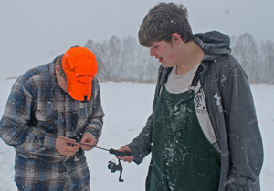 image of teen baiting fish hook