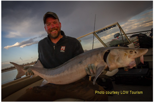 image of bret amundson with big sturgeon