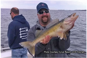 image of angler with big walleye