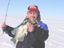 image of ice fisherman with big crappie