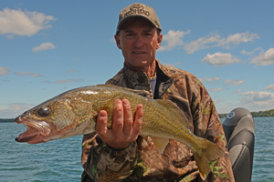 image of Tim Welu with leech lake walleye