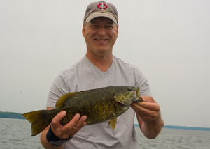image of Tim Heerts with Pokeagama Lake smallmouth