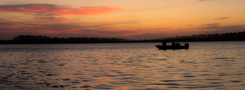 silhouette of boat and sunset