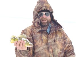 Tim Schultz, owner of the 
    Bowstring Store shows off a nice Lake Winnie Winter Jumbo Perch