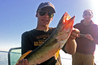 Son Jack proudly displays one of his many “releaser” Winnie walleyes caught in the fog as dad Doug waits to take another photo.