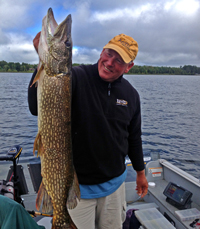 image of Jeff Sundin holding monster pike on fishing trip