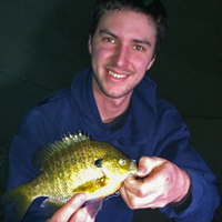 image of ice fisherman holding sunfish