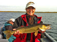 Gail Heig holding 26 inch Walleye