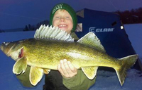 Image of Caden Carpenter holding large Walleye