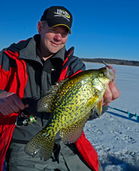 image of Dan Johnson holding slab crappie on ice