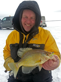 image of Crappie Fishing Guide Jeff Sundin holding Crappie on the ice