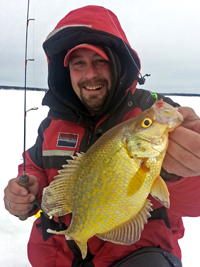 image of Zach Dagel holding Crappie on ice fishing trip