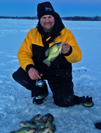 image of Jon Thelen with Crappies on the ice