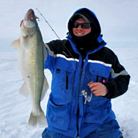 image of Brett McComas holding large Walleye on the ice