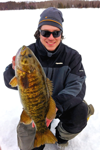image of Nik Dimich holding Trophy Smallmouth Bass Ice Fishing