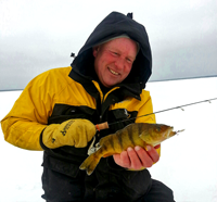 image of fishing guide jeff sundin holding perch on ice