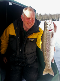 image of ice fisherman holding Rainbow Trout on Ice