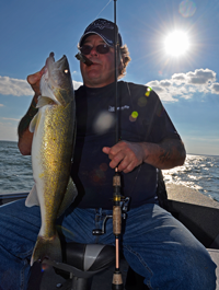 image of Kyle Reynolds with a big Leech Lake Walleye