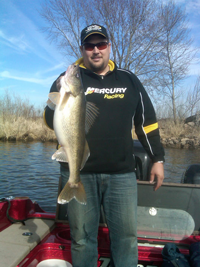 image of jason Muche holding giant walleye