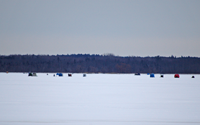 image of ice fishermen on round lake
