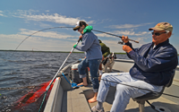 image of Annalee Sundin netting fish for Bob Carlson