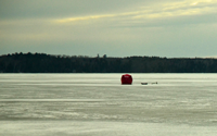 image of an ice fishing shelter on the ice