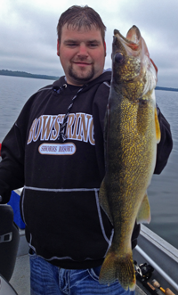 image of Dustin with a big Lake Winnie Walleye