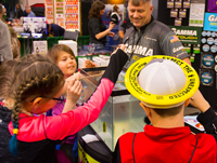 image of kids gathered around the gamma fishing line booth