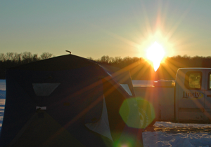 image of pickup and ice shelter on ice