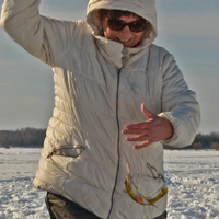 image of woman reeling in perch