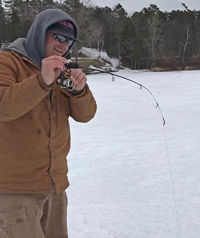 image of pat everson reeling in fish