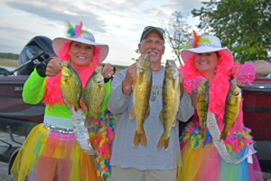 image of lori, lonnie and phil with mixed bag of fish