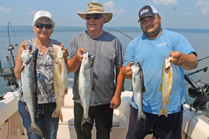 image of mike mary and andy walsh with trout