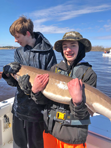 image of boys with huge sturgeon